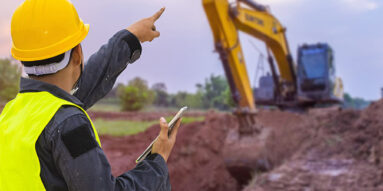 Construction trench, bulldozer, hard hat