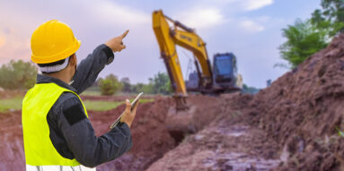 Construction trench, bulldozer, hard hat