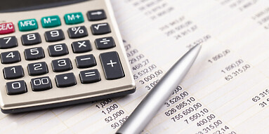 Spreadsheet and calculator on desk